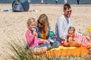 A family enjoying Great Yarmouth Beach in Norfolk.