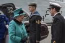 The Queen is greeted by Comdr Andrew Canale as she arrives at HMS Sutherland in Millwall's West India Dock for the 20th anniversary of its commissioning. Picture: Arthur Edwards/The Sun/PA Wire