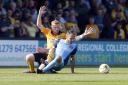 Leyton Orient midfielder Liam Kelly is fouled by Cambridge United's Liam O'Neil (pic: Simon O'Connor).