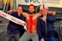 Alfie Callagher-Roberts (centre) has shaved his chest hair to a cross shape and dyed it red to support England and charity Construction Sport, which is fighting suicide rates in the trade
