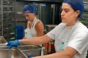 Olivia Burt and Ixta Belfrage volunteering at the Felix Project kitchen