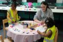 Student running toddlers' activity session on college childcare course