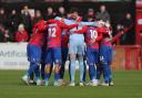 Dagenham & Redbridge players huddle before kick-off at Victoria