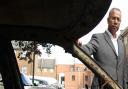 Then Tower Hamlets mayor Lutfur Rahman inspects a burnt-out car on the Isle of Dogs after the 2011 riots
