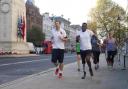 Ben McBean in Whitehall on his 31-mile run through the streets using the outline of a poppy on the London map [photos: David Parry/PA Wire]