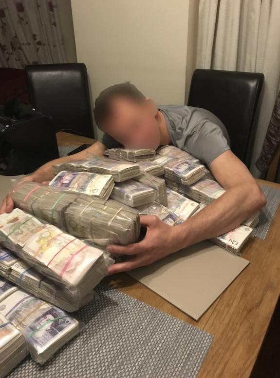 East London Advertiser: Hugging cash in Deivis Grochiatskij's Dockland's flat East London Advertiser: Hugging cash in Deivis Grochiatskij's Dockland's flat