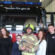 Wayne Crossman (centre) was accompanied by his family as he retired from the fire service