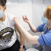 A nurse administers a coronavirus vaccine