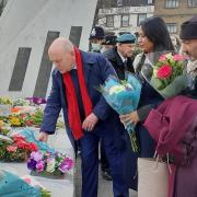 Tower Hamlets mayor John Biggs lays flowers on the memorial