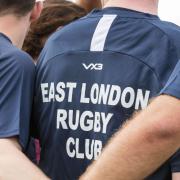 East London rugby players huddle together