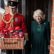 The Queen Consort delivers a basket of Paddington bears at a special teddy bears picnic at a Barnardo's Nursery in Bow