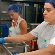 Olivia Burt and Ixta Belfrage volunteering at the Felix Project kitchen
