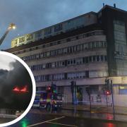 A video shows the roof above the flats ablaze and smoke billowing