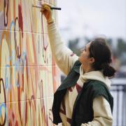 Lydia Hamblet working on her art commission at Canary Wharf