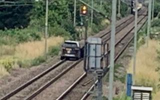 A black Land Rover Discovery sped onto railway tracks near Cheshunt during a police chase